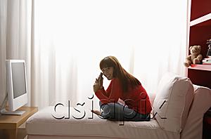 AsiaPix - young girl watching TV in her bedroom