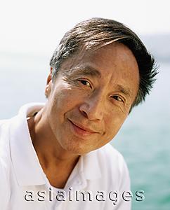 Asia Images Group - Mature man outdoors, sea in background, portrait