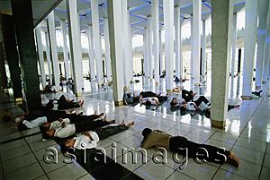 Asia Images Group - Malaysia, Kuala Lumpur, men resting after Friday Prayers in the National Mosque.