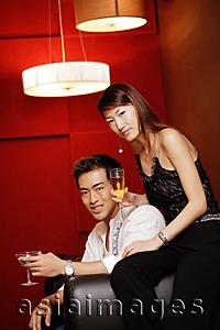 Asia Images Group - Couple, holding drinks, looking at camera