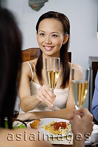 Asia Images Group - Woman raising glass in toast