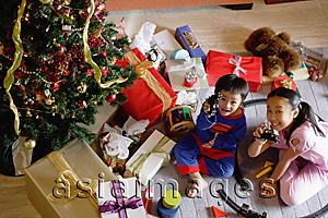 Asia Images Group - Children with opened Christmas presents, showing toys to camera