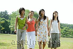 Asia Images Group - Young women walking side by side in park