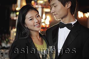 Asia Images Group - Young couple dressed up at night holding champagne glasses