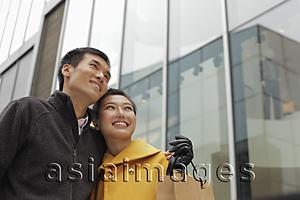 Asia Images Group - Young couple smiling and looking up