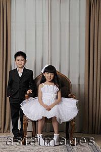 Asia Images Group - Young boy and girl dressed up in nice clothes smiling