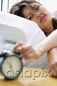 AsiaPix - Woman reaching to switch off alarm clock