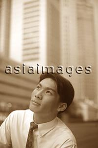 Asia Images Group - Male executive looking up, thoughtful expression