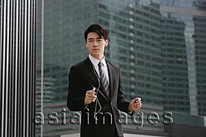 Asia Images Group - Businessman listening to MP3 player