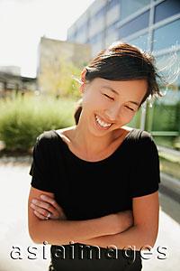 Asia Images Group - Woman smiling and looking down, outdoors
