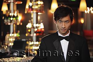 Asia Images Group - Young man wearing a tuxedo at night