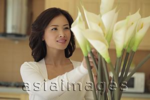 Asia Images Group - Young woman arranging flowers