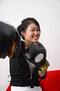 AsiaPix - Young woman with boxing gloves