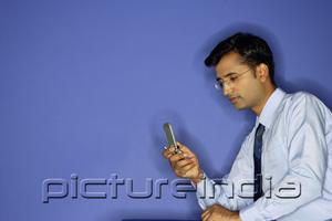 PictureIndia - Man using mobile phone